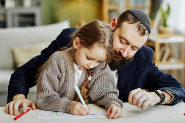 Portrait of caring jewish father drawing pictures with daughter at home - obrazy, fototapety, plakaty