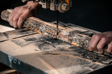 Worker in the carpentry workshop cuts the log into boards using band saw. Joinery. Raw wood Wooden crafts. Work at the factory. Working band sawmill in action, close-up. 