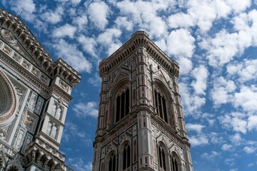 Low angle of the Florence Cathedral in Italy with a cloudy blue sky in the background.
