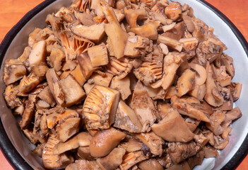 Tasty edible mushroom Lactarius deliciosus sliced for loading and preparing soup