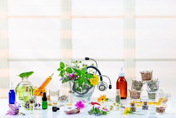Natural healthcare concept-Herbal plant medicine preparation with herbs and flowers, mortar with pestle .and stethoscope - obrazy, fototapety, plakaty