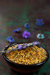 healthy bee pollen grains on wooden background