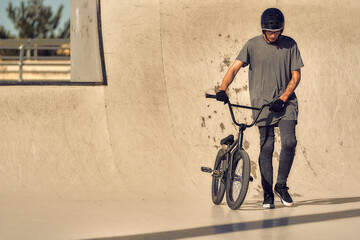 boy in a skatepark riding a bike and enjoying himself