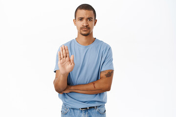 Please stop. Concerned man shows palm taboo gesture, refusing, rejecting and prohibiting smth,...