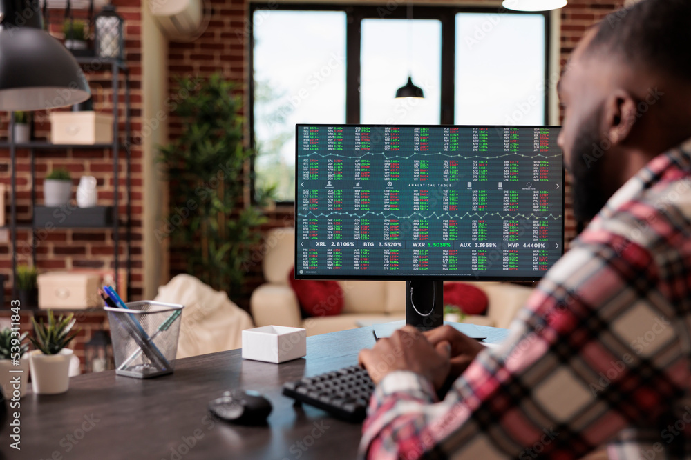 Poster office worker analyzing stock market statistics on computer, looking at real time trade exchange wit