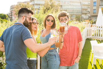 Happy young people drinking in outside – group of friend toasting at kiosk bar – event at pool...