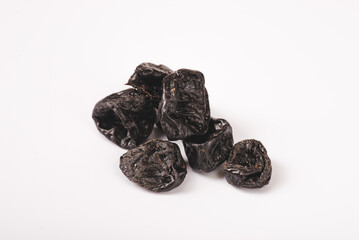 Prunes isolated on white background, heap of dried plums