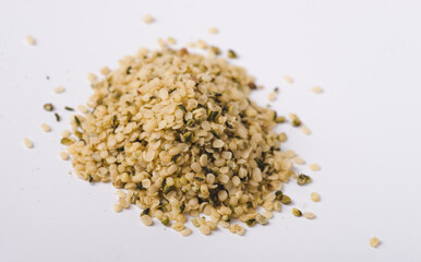 Heap of hemp seeds on white background