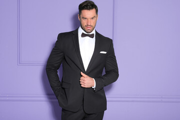 Elegant handsome model in black tuxedo.
