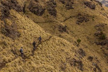SIMIEN MOUNTAINS, ETHIOPIA - MARCH 16, 2019: Tourists hiking in Simien mountains, Ethiopia