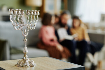 Close up of silver Menorah candle on table in jewish family home, copy space