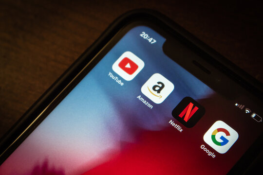 Vancouver, CANADA - Oct 17 2022 : Netflix icon with YouTube, Amazon and Google icons on an iPhone in dark mood.