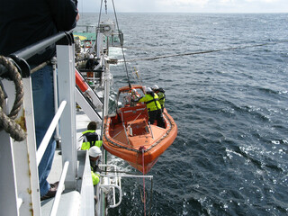 Preparing Fast Rescue Boat (FRC) for launching from a ship. FRC is used in search and rescue...