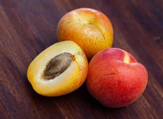 Naklejka na ściany i meble Fresh organic apricots on wooden background, fruit vegan food