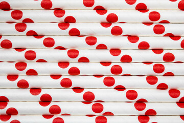 Red paper straws in abstract format. Mention the sustainable party, replacement of plastic in people's routine and get-togethers for actions in support of the environment. 3D effect background.