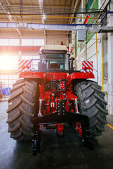 Rear view of modern agricultural tractor in hangar. Hydraulic hitch. Hydraulic lifting frame. Rear...