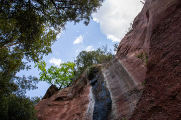 Fototapeta premium Small natural waterfall that marks the wall of the mountain of colors