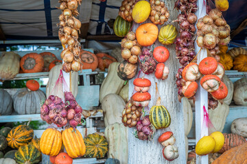 Watermelons, onions and melons are sold in market on the side of the road