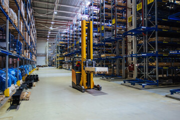 Moving forklift loader in modern warehouse, motion blur