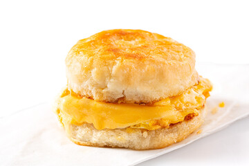 Breakfast egg and cheese sandwich on a white background with copy space