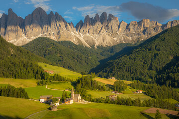 Fototapeta na wymiar St. Magdalena with famous church in Val di Funes at sunset, Dolomites , Italy