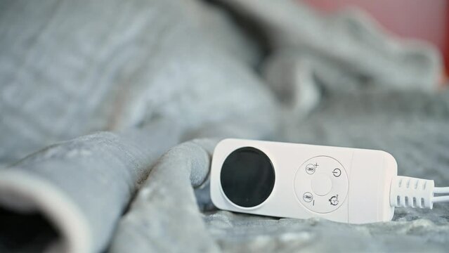 electric blanket with controller with a sleeping people on the background