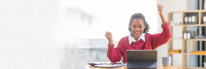 
Excited happy african american woman looking at laptop screen, celebrating an online win,...