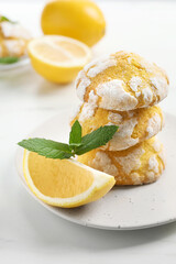 Tasty homemade lemon cookies with fresh fruit and mint on white marble table