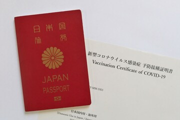 Japanese passport and Proof of COVID-19 Vaccination issued in Japan. Tokyo, Japan. October 19, 2022.