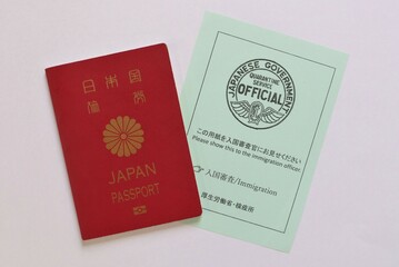 Japanese passport and immigration document handed at Haneda Airport, Tokyo, Japan. October 19, 2022.