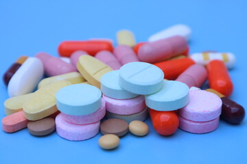 capsules pill on blue background. Antibiotics drug resistance. Antimicrobial capsule pills. Pharmaceutical industry. With space for text or image. great for background. 