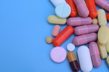 capsules pill on blue background. Antibiotics drug resistance. Antimicrobial capsule pills. Pharmaceutical industry. With space for text or image. great for background. 