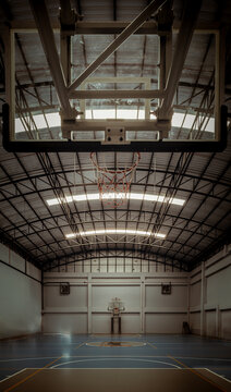 View From Empty Basketball Gym. Indoor Basketball Court, Interior Of A Basketball Hall, Space For Text, Dark Tone, Selective Focus.