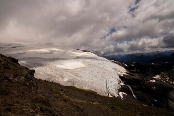 View of the Andes mountain range and Glacier Alerce in Pampa Linda, Río Negro, Argentina, from the top of Tronador hill. Beautiful ice field texture and color under a cloudy sky. 