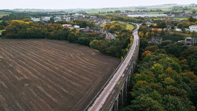 Drone video footage of the Penistone Railway Viaduct near Barnsley, South Yorkshire.
Showing a ploughed field, bridge, woodland and railway tracks.
