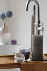 Wooden bathtub tray with candles, closeup