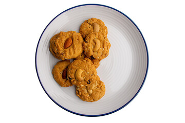 Homemade almond cookies in ceramic white plate on transparent background.