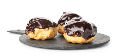 Slate board with delicious eclairs on white background