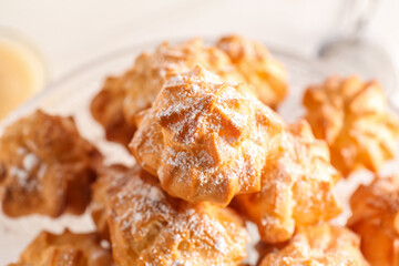 Delicious eclairs with sugar powder, closeup