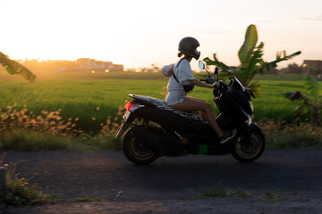 Fototapeta na wymiar young girl on a motor scooter