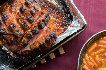 Top down view of a roasted smoked picnic ham ready for carving.