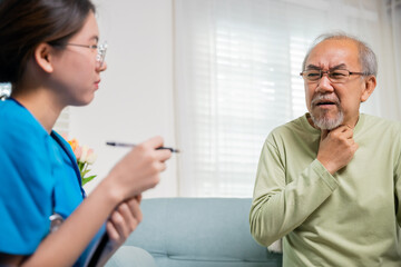 Asian young nurse checking senior man neck pain in clinic at retirement home, doctor woman examines...
