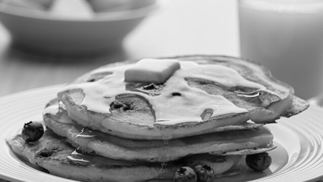 Stack of pancakes with breakfast spread