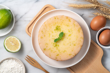 Delicious Lemon Glazed Pound Sponge cake on white marble table background.