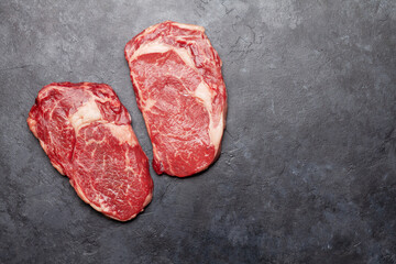 Two raw ribeye beef steaks