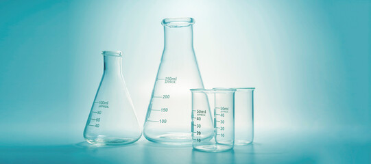Glass chemistry lab equipment on blue background. Chemistry Lab concept.