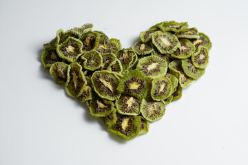 Natural Dried Kiwi Slices Snack in heart shape. Dried Kiwi for baking.  Isolated white background....