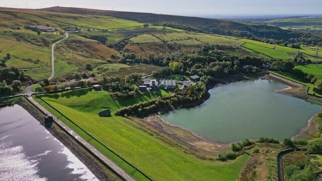Aerial drone video footage taken at Ogden near Saddleworth moor of a series of Lakes, Reservoirs, set against a backdrop of moorland and woodlands.