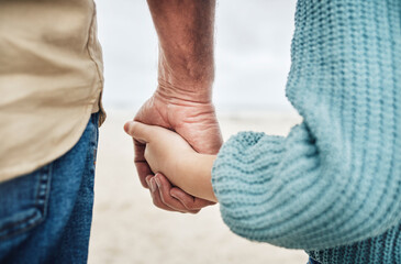 family, beach and father holding hands with kid in support, child care trust and love while enjoy peace, freedom or bond. Quality time, travel and young youth girl and dad relax together on calm sand - Powered by Adobe