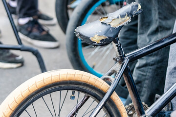 Bicycle for jumps and tricks BMX in a skatepark with a torn seat. Sports bike close up. Cycling.